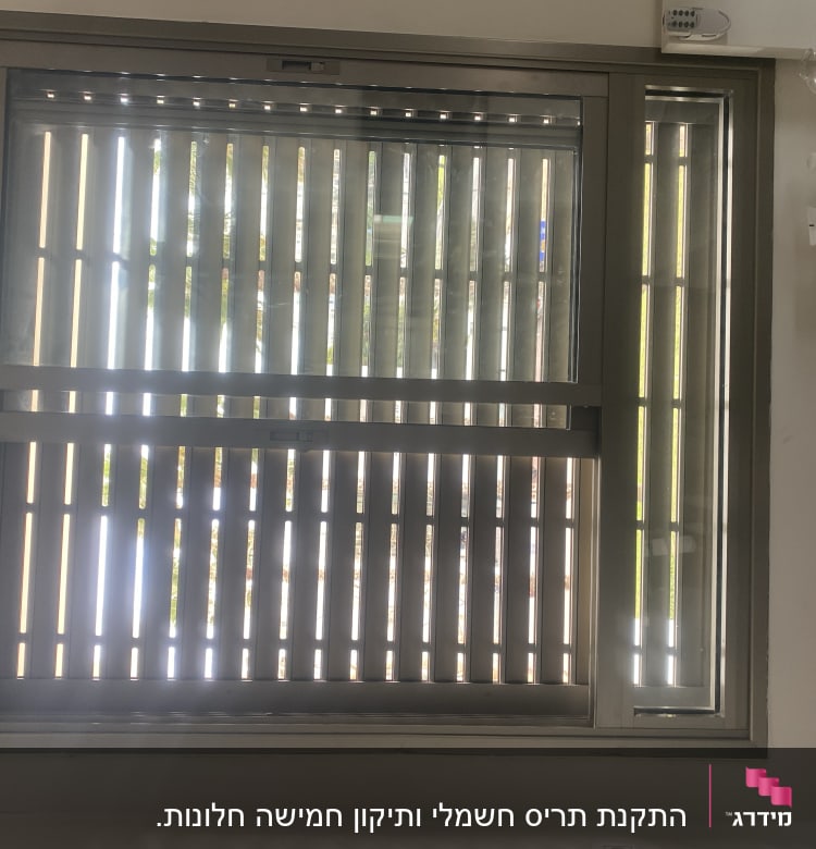 תריסים סגורים עם חריצים לאור על חלון זכוכית